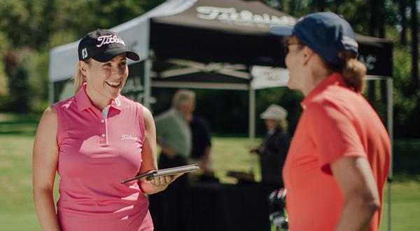 Golfer talking to fitting expert about club fitting