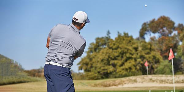 Golfer swinging golf club to warm up for club fitting