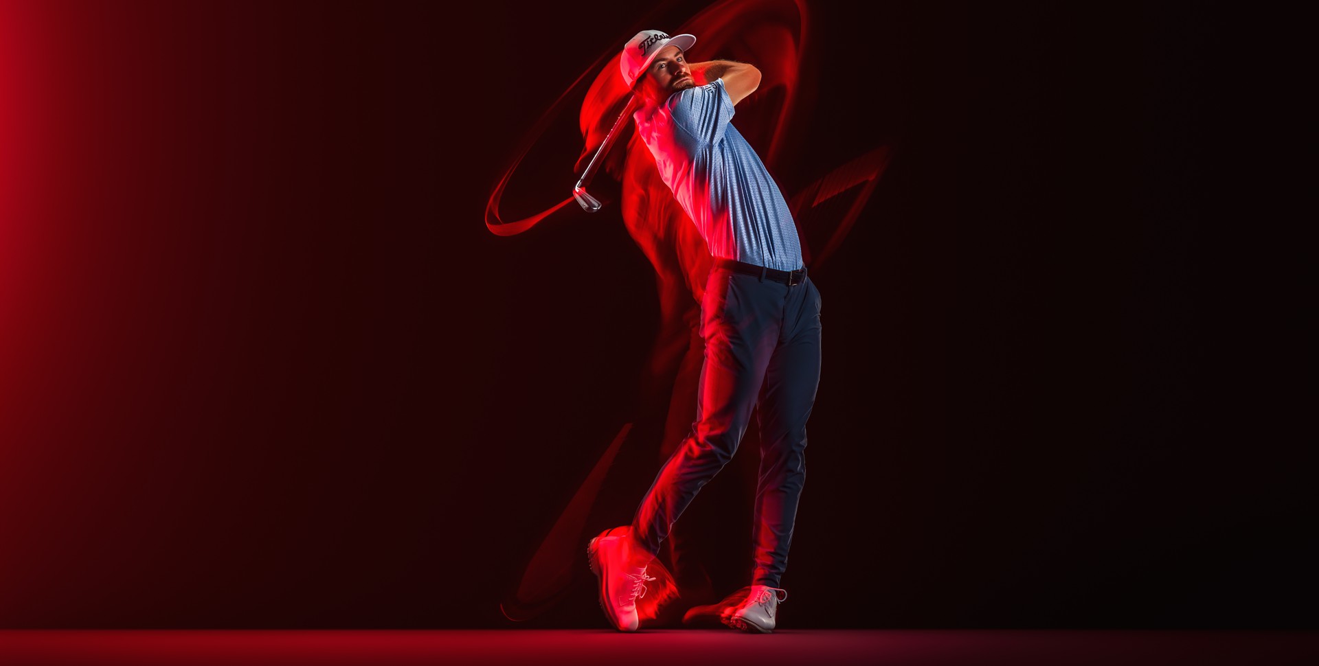 Golfer swinging an iron